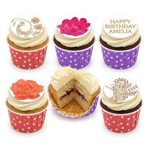 Selection of floral cupcakes with white frosting, some with red and purple polka dot wrappers, including a custom 'Happy Birthday' message cupcake.