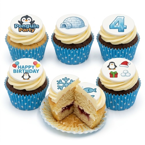 Cupcakes with white frosting and blue polka dot cases, topped with edible discs featuring cartoon penguins, an igloo, a snowflake, and the number 4, with one cupcake cut open showing jam filling.