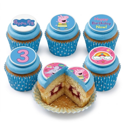 Peppa Pig themed cupcakes with blue frosting, polka dot wrappers, and edible toppers including Peppa Pig, a rainbow, and a number 3.