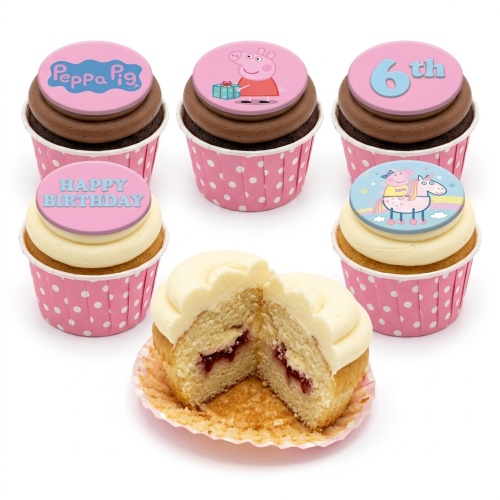 Collection of Peppa Pig and unicorn themed birthday cupcakes in pink polka dot wrappers with 'Happy Birthday' and '6th' toppers.