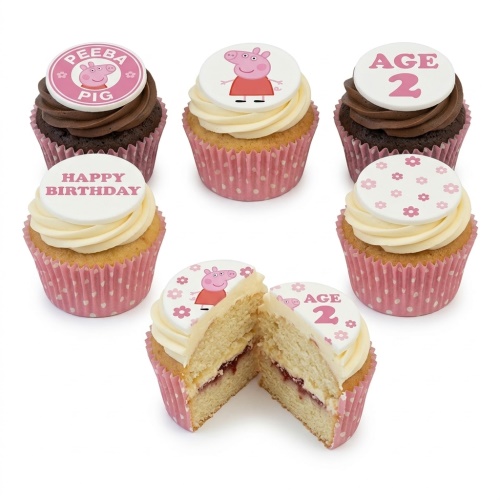Peppa Pig themed birthday cupcakes with pink polka dot cases and custom age toppers.