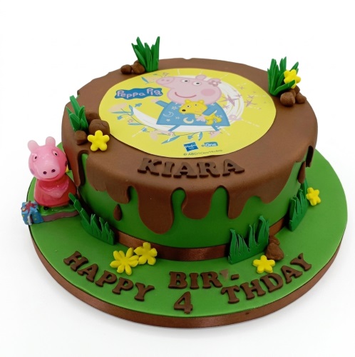 Round Peppa Pig themed birthday cake with a brown drip, green base, edible image, and Peppa Pig figurine.