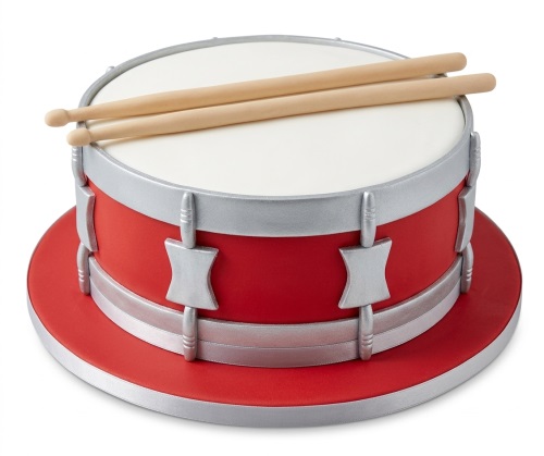 Red and white drum-shaped birthday cake with silver details and edible drumsticks.