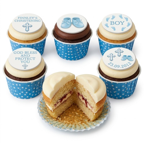 Blue and white christening cupcakes for boys with cross, baby booties, and "BOY" toppers.