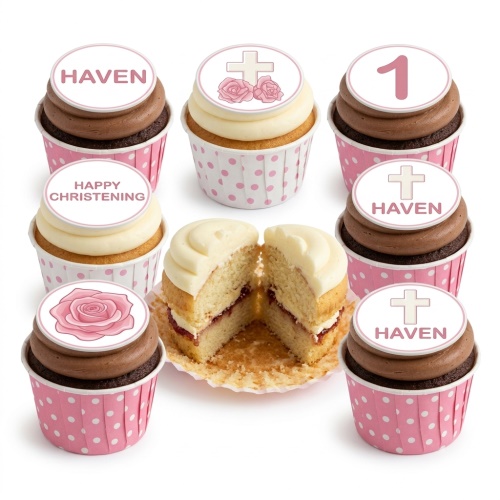 Christening cupcakes with white and chocolate frosting, pink polka dot wrappers, and edible toppers featuring crosses, roses, a number 1, and custom messages.