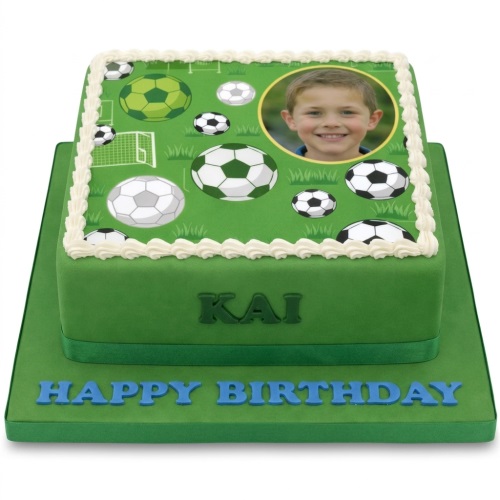 Two-tier green football themed birthday cake with edible footballs, a goal, and a circular photo on top.