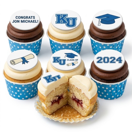 Graduation cupcakes with blue and white polka dot cases, topped with edible graduation caps, diplomas, and university logos.