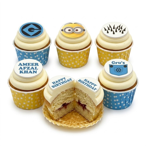 Minions theme birthday cupcakes with character toppers and polka dot wrappers.