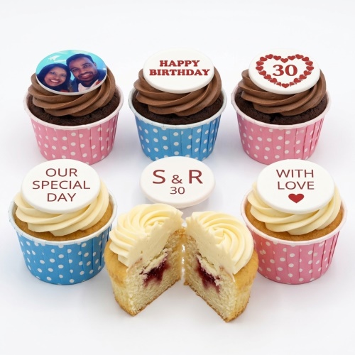 Set of personalised photo birthday cupcakes with custom age and messages, in pink and blue polka dot cases.