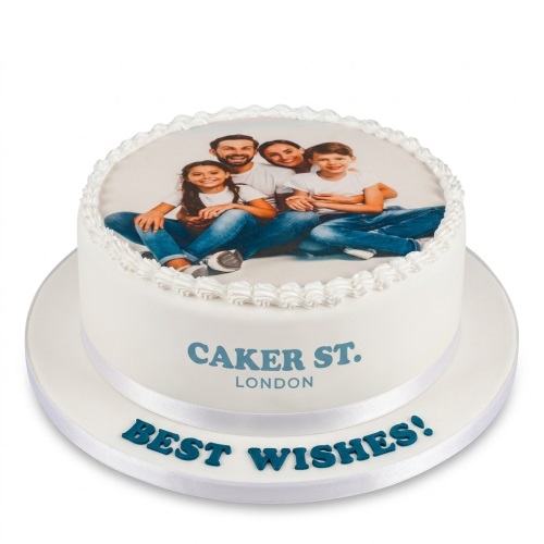 Round white cake with a custom family photo print on top and 'Best Wishes' message.