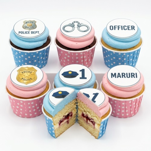 Set of police theme cupcakes with blue and pink frosting, decorated with police badges, handcuffs, and a police hat.