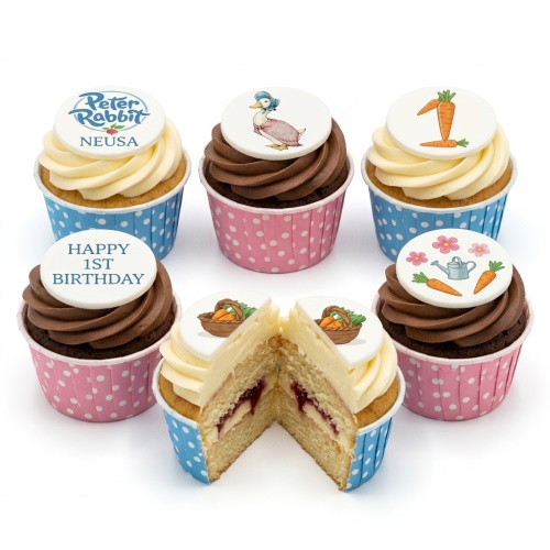 Peter Rabbit 1st birthday cupcakes with various character toppers, carrots, and custom message.
