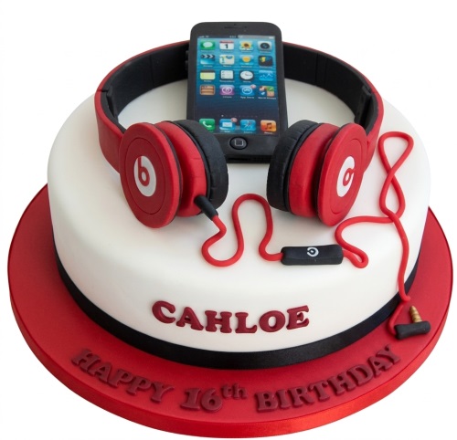 White birthday cake with red headphones and a black smartphone on top, with custom name and message.