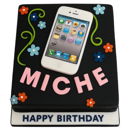 Black square birthday cake with a white iPhone decoration, pink custom name, and colourful flowers.