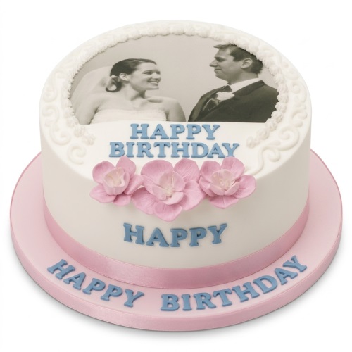 Round white birthday cake with an edible photo print and pink sugar flowers.