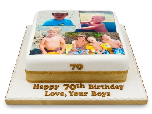 Two-tier white 70th birthday cake with edible photos and gold decorations.