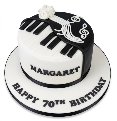 Elegant white and black round cake with a piano keyboard and musical notes design, adorned with white sugar roses.