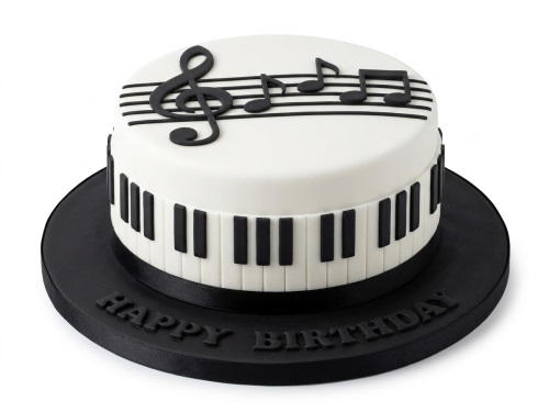 Round white cake with black piano keys and musical notes, "Happy Birthday" on board.