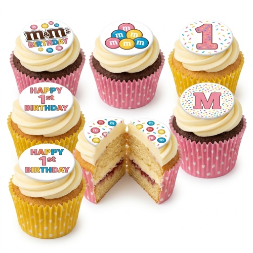 M&M's themed cupcakes with white frosting, colourful sprinkles, and 'Happy 1st Birthday' and initial 'M' toppers.