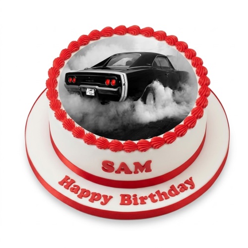 Two-tier white birthday cake with red piping and ribbon, featuring an edible image of a black classic car doing a burnout. Custom name and message example.