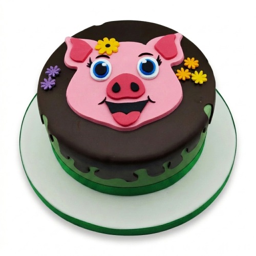Round birthday cake with a pink pig face topper, chocolate drip, green base, and small sugar flowers.