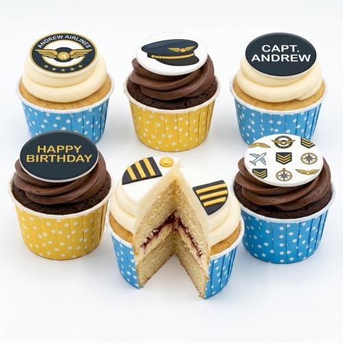 Six cupcakes with pilot and aviation themed toppers, including a pilot hat, airline logo, and 'Happy Birthday' message, in blue and yellow polka dot cases.