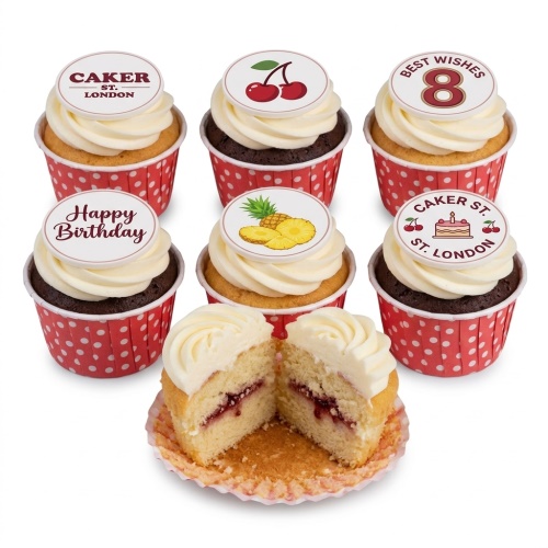 A selection of vanilla and chocolate birthday cupcakes with white buttercream and edible toppers including fruit, 'Happy Birthday', and 'Best Wishes 8'.
