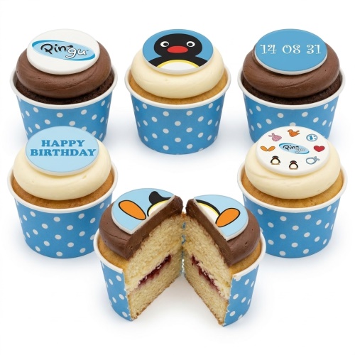 Pingu themed birthday cupcakes with blue polka dot wrappers, vanilla and chocolate frosting, and custom message toppers.