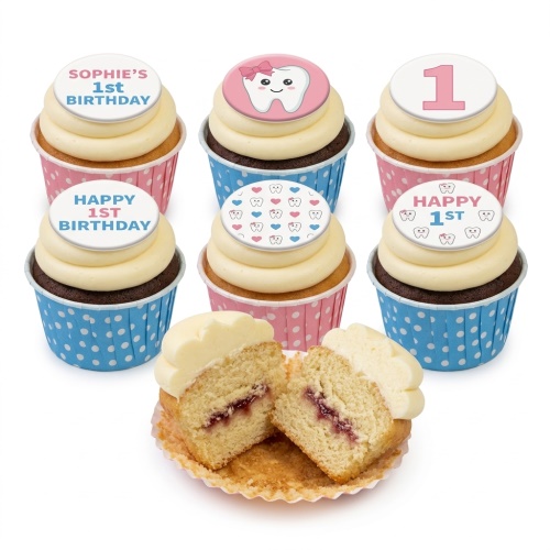 Six cupcakes with light frosting and round toppers. Toppers feature a pink tooth character, the number 1, small teeth and heart patterns, and '1st Birthday' messages. Cupcakes are in pink and blue polka dot cases.