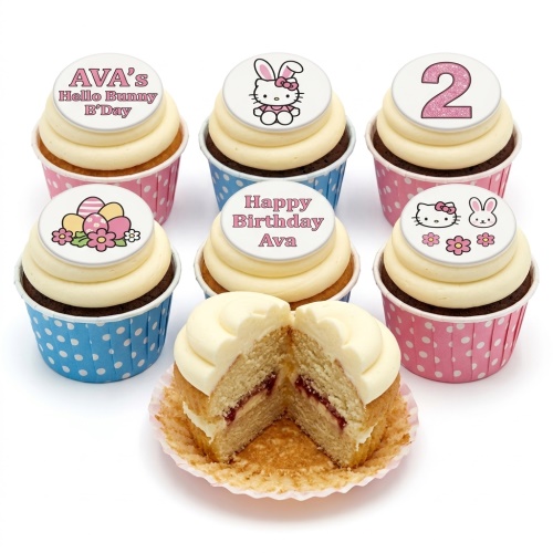 Set of Hello Kitty themed birthday cupcakes with custom age and name toppers, in pink and blue cases.