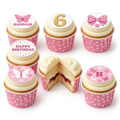 Pink and white cupcakes with butterfly, bow, and custom age toppers in pink polka dot cases.