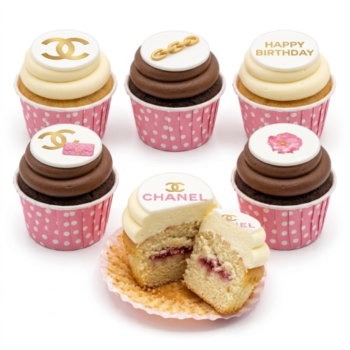 White and brown cupcakes with Chanel logo, handbag, chain, flower, and 'Happy Birthday' toppers.