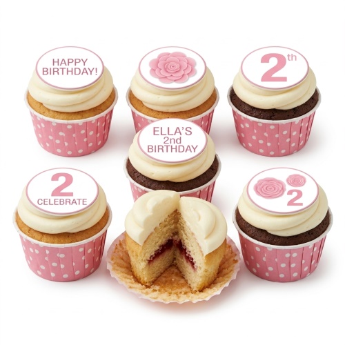 Pink and white cupcakes with rose and custom age toppers in polka dot cases.
