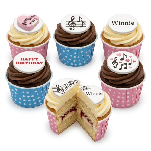 Music themed cupcakes with musical notes, piano keys, and pink hearts on white fondant toppers.