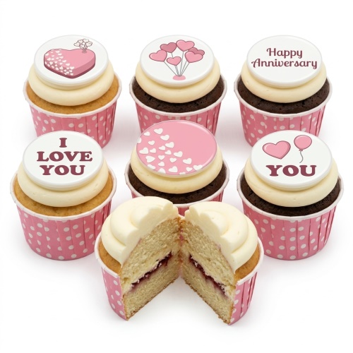 Cupcakes with pink and white heart toppers and romantic messages.