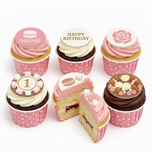 Collection of pink and white birthday cupcakes with rose, macaron, and custom age '1' toppers.
