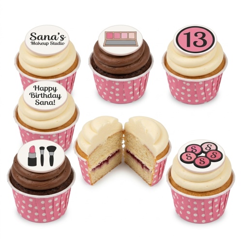 A set of cupcakes with white and chocolate frosting, pink polka dot wrappers, and edible makeup-themed toppers, including an eyeshadow palette, lipstick, brushes, and a custom age number.