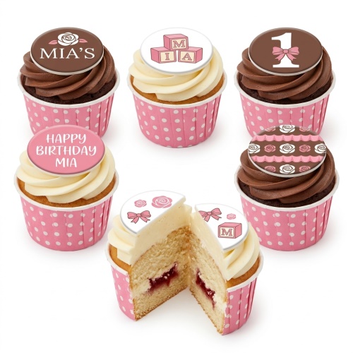 Pink and brown cupcakes with baby blocks, number one, and rose toppers for a girl's first birthday celebration.