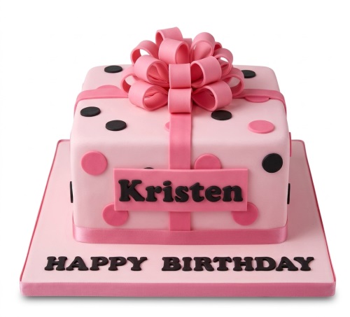 Pink gift box birthday cake with a large pink bow, pink ribbon, and pink and black polka dots, with a custom name plaque and "Happy Birthday" message.