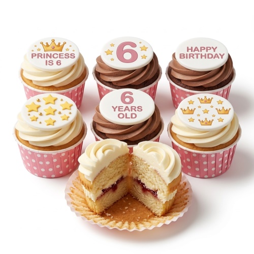 Cupcakes with white and brown frosting, golden crown and star toppers, in pink polka dot wrappers.