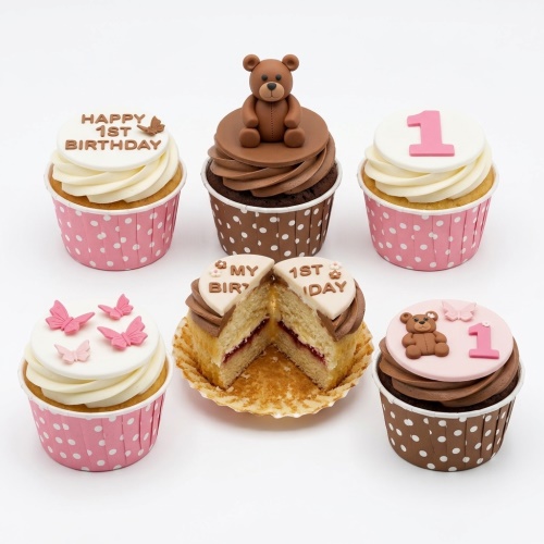 Set of 1st birthday cupcakes with teddy bears, pink butterflies, '1' toppers, and 'Happy 1st Birthday' messages.