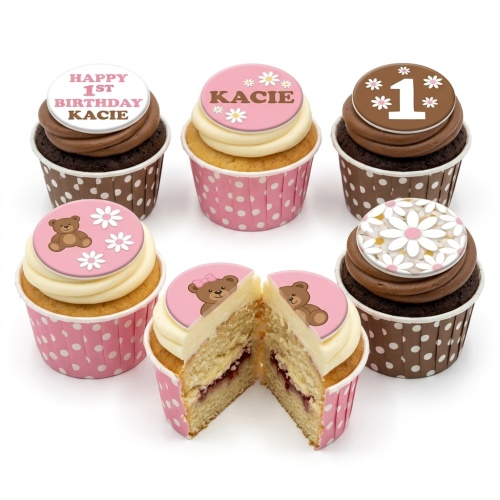 Assorted baby girl birthday cupcakes with teddy bear, daisy, and custom age toppers