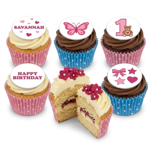 Vanilla and chocolate cupcakes with pink and blue cases, topped with custom butterfly, teddy bear, bow, and 'Happy Birthday' designs.