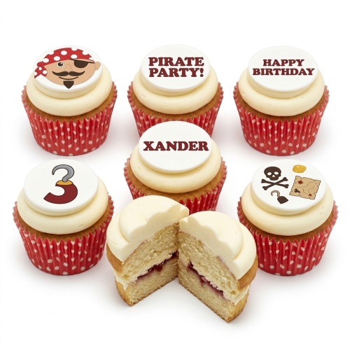 Vanilla cupcakes with white frosting and pirate-themed edible toppers, including a pirate face, skull, treasure map, and custom age '3'.
