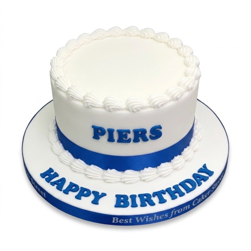 Round white birthday cake with blue ribbon and custom blue lettering for a personalised message.