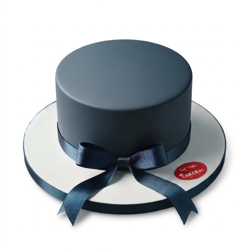 Single-tier novelty cake shaped like a dark blue top hat with a satin ribbon bow.
