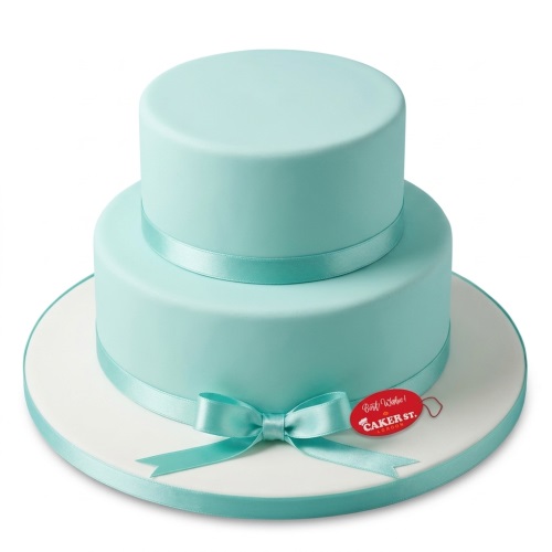Two-tier aqua blue birthday cake with a satin ribbon and bow.