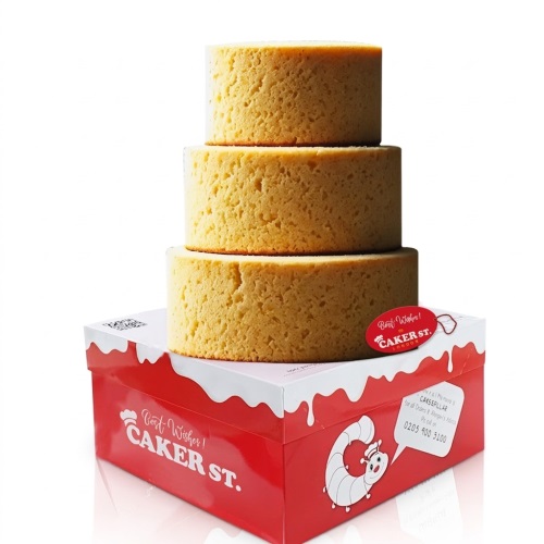Three round, plain sponge cake tiers stacked on a red and white Caker Street delivery box.