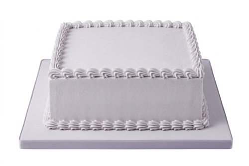 Square cake with smooth light purple icing and piped shell borders on white background.