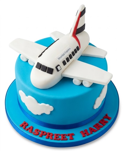Blue fondant birthday cake with a white 3D aeroplane topper and white clouds.